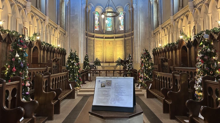 Community decorated trees sparkling in the chapel at Killerton, Devon